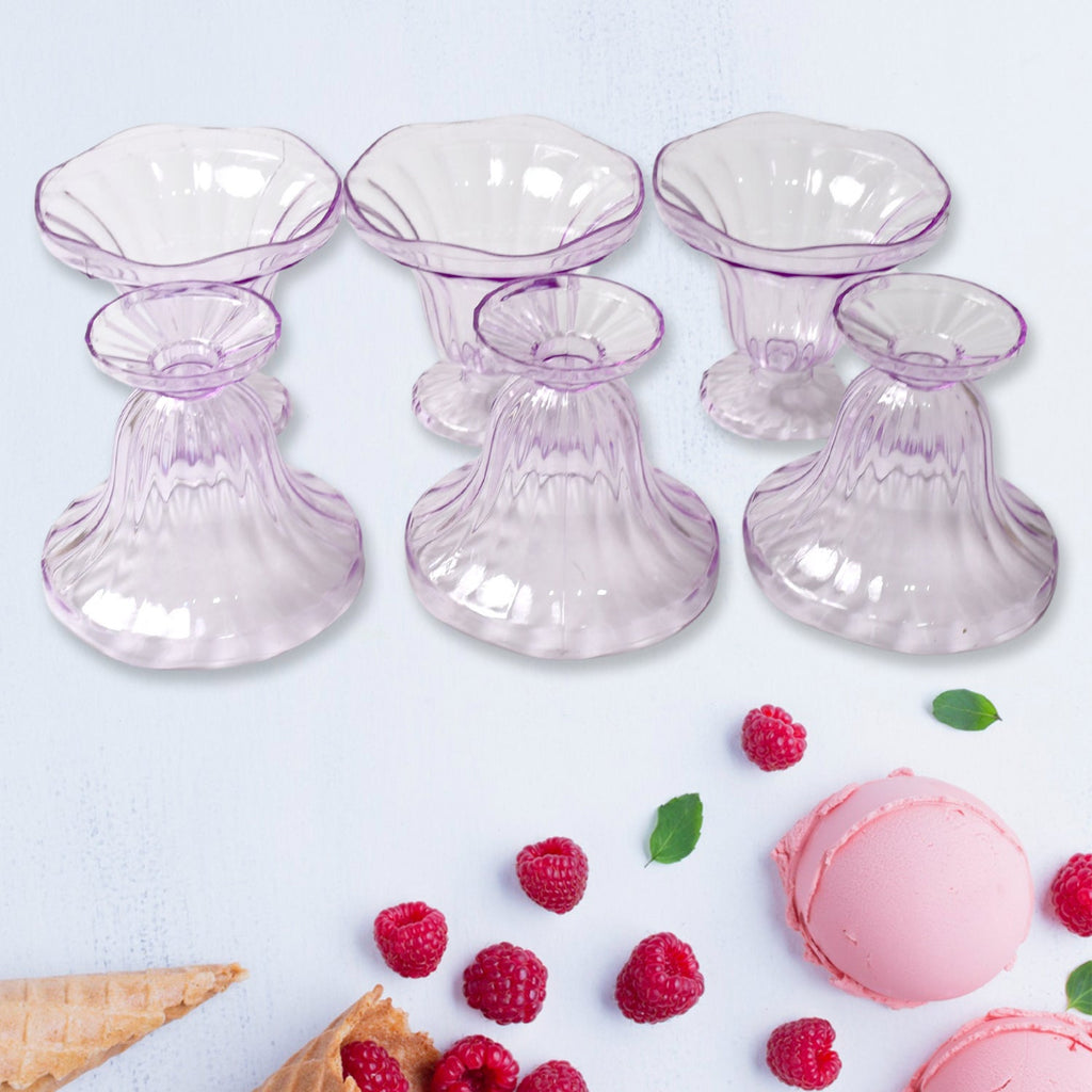 Clear plastic serving bowls displayed with various fruits and snacks.
