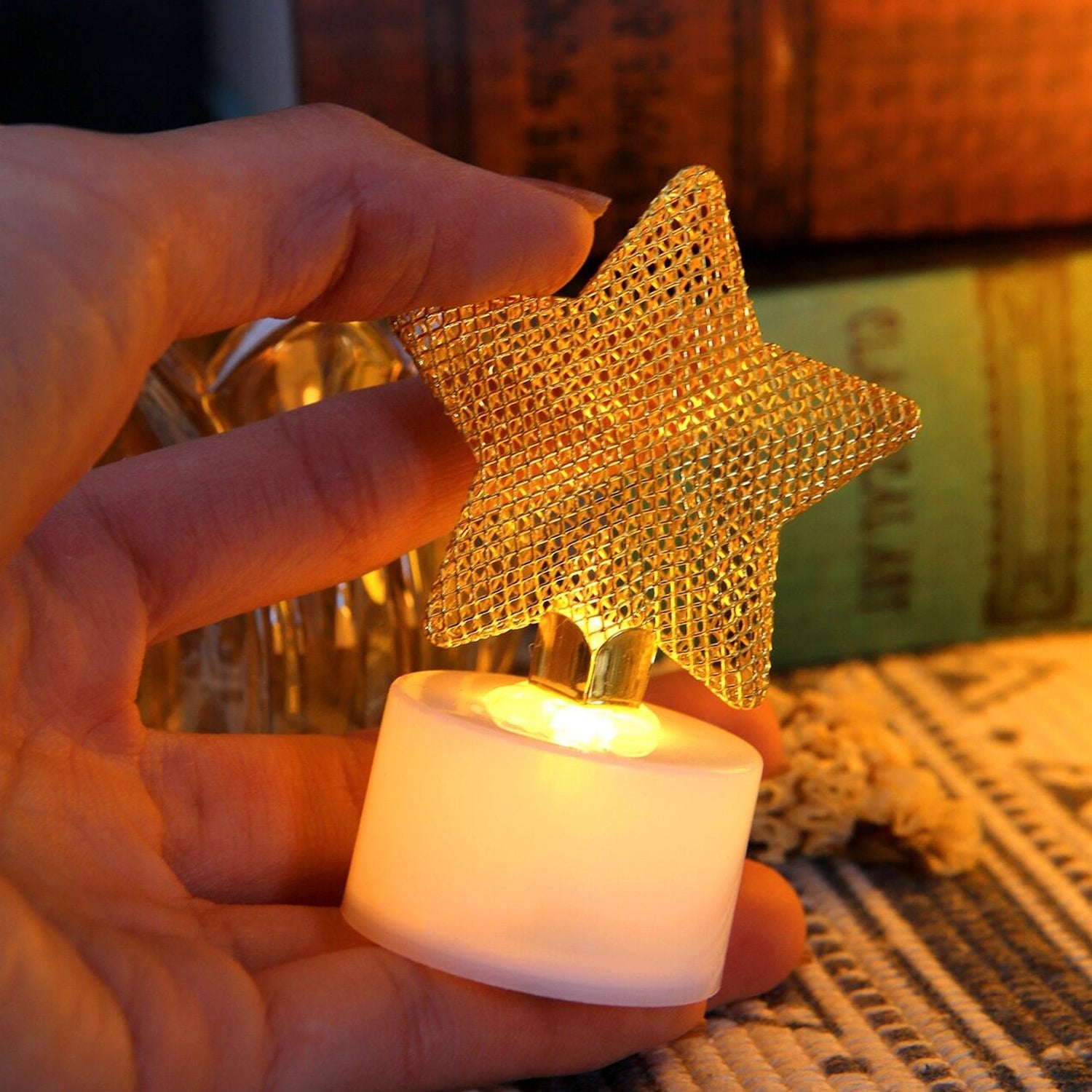 Three flameless LED candles placed on a table as part of a festive Diwali lighting display.