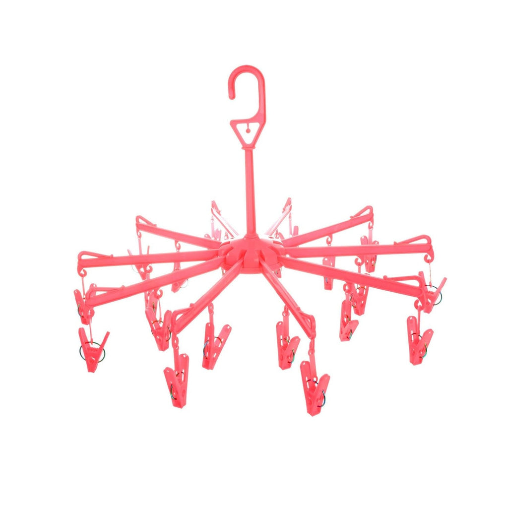 Close-up of the clothes clips hanger securely holding baby clothes for quick drying.