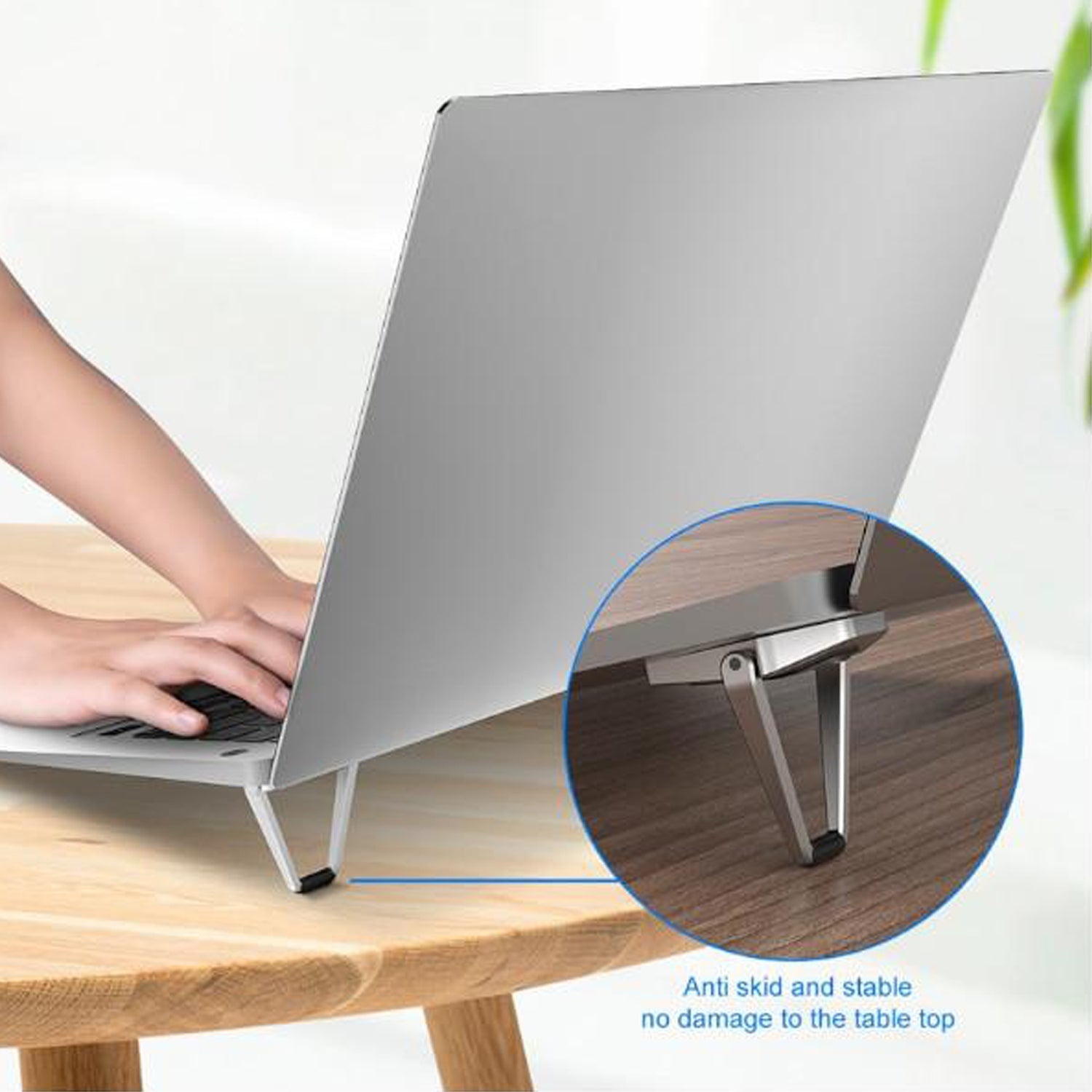Close-up of the durable metal construction and non-slip rubber pads of the foldable laptop stand.