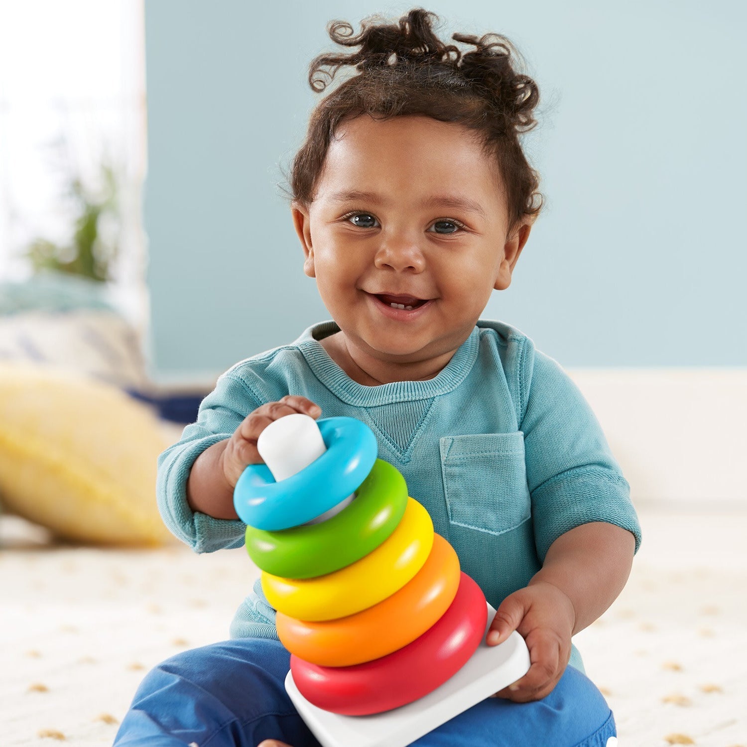 Colorful plastic stacking rings with a cute teddy bear head for kids.