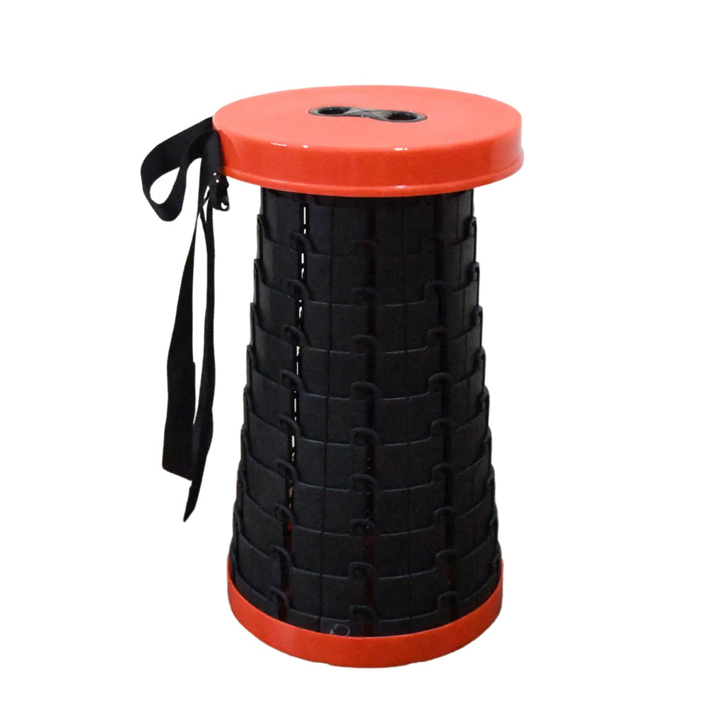 A lifestyle shot of the portable folding stool being used outdoors for a camping activity.