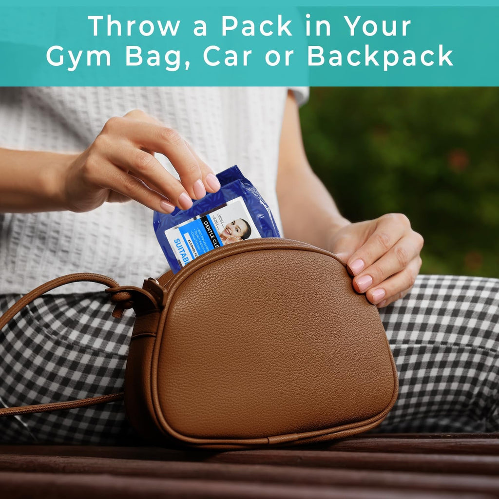 Hand pulling a gentle alcohol-free wet wipe from the pack for on-the-go freshness.