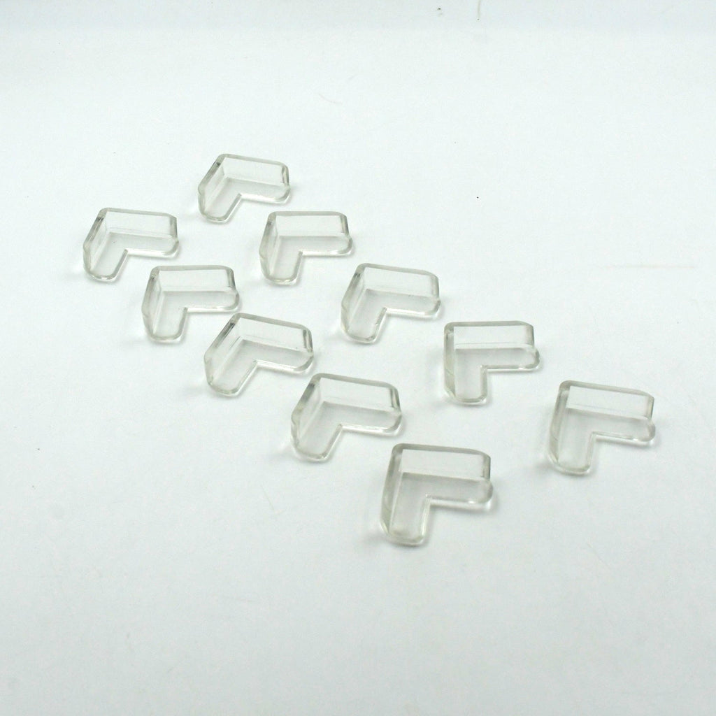 Multiple clear corner guards effectively applied to sharp furniture edges in a home.