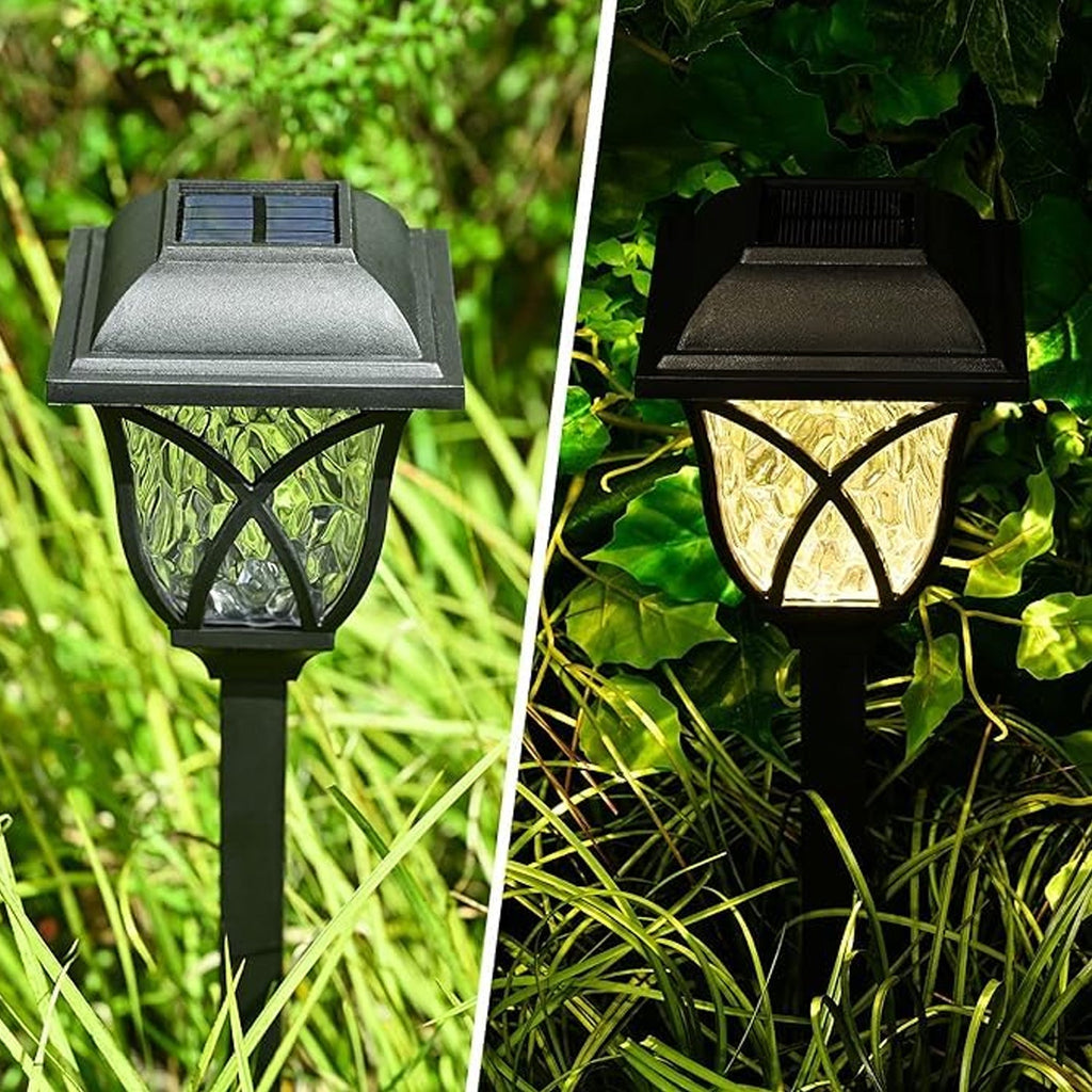 A pair of FitFuzion solar pathway lights installed in a lush green garden, showcasing their elegant design.