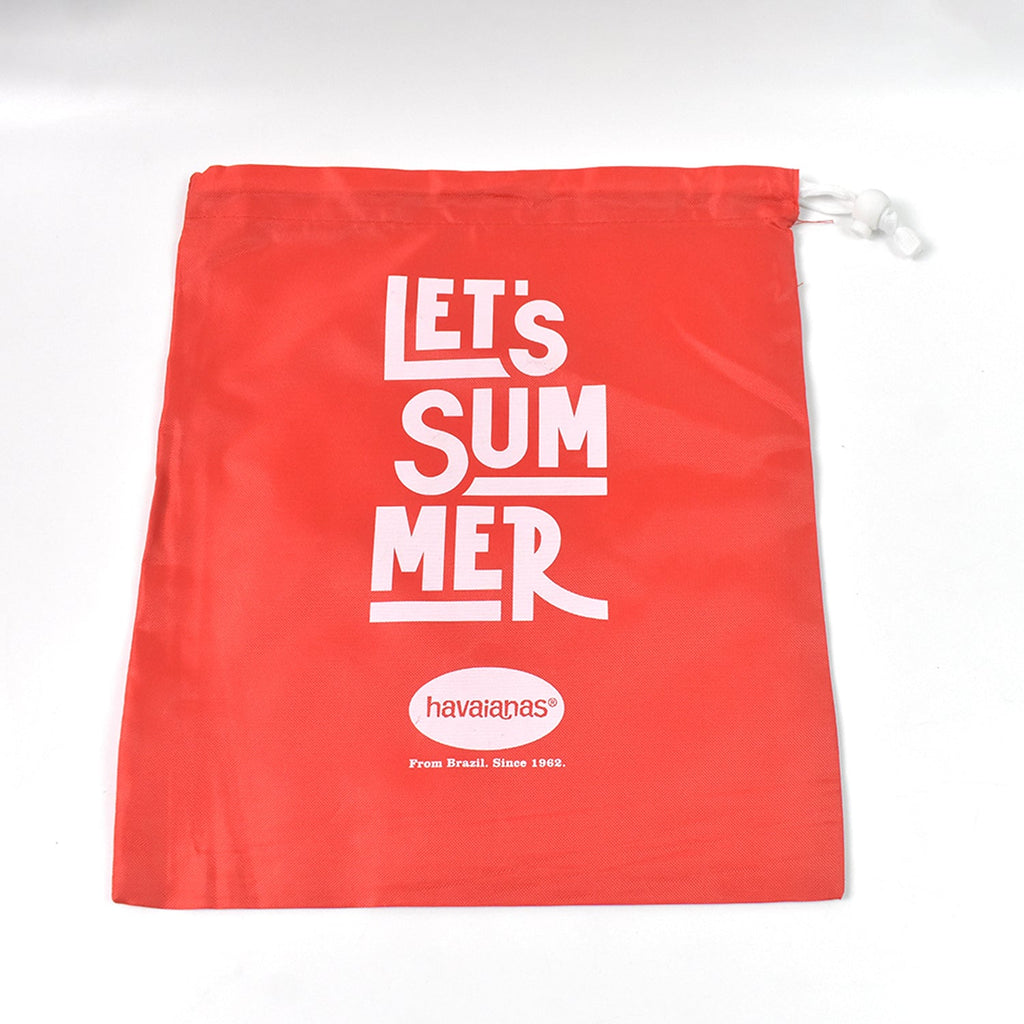 Stack of red multipurpose drawstring bags, highlighting their versatile use.