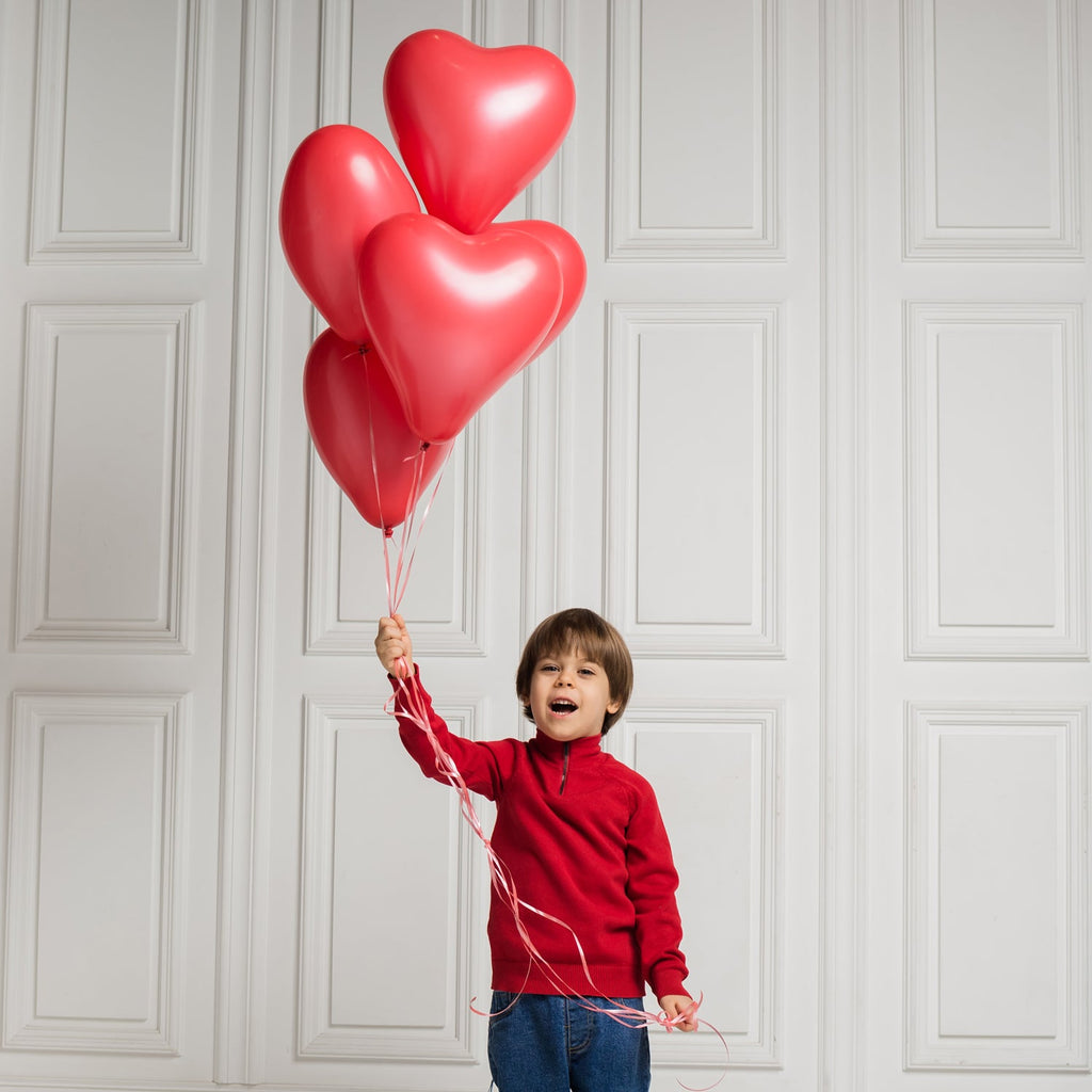 A collection of inflated heart shaped balloons ready for a party.