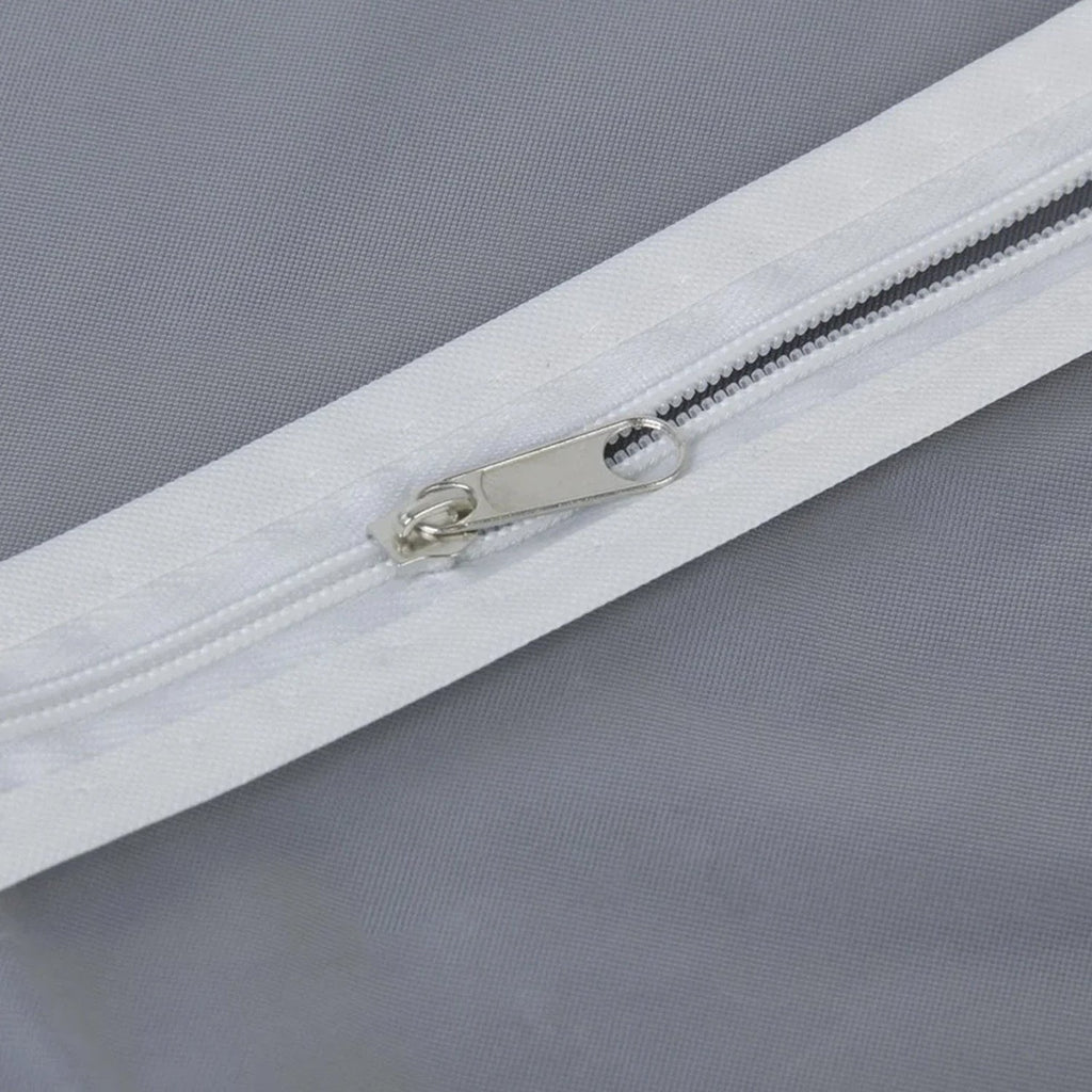 Closeup of full-length zipper on suit cover with breathable fabric.