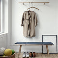 Single wooden clothes hanger with a notched design for coats and suits.