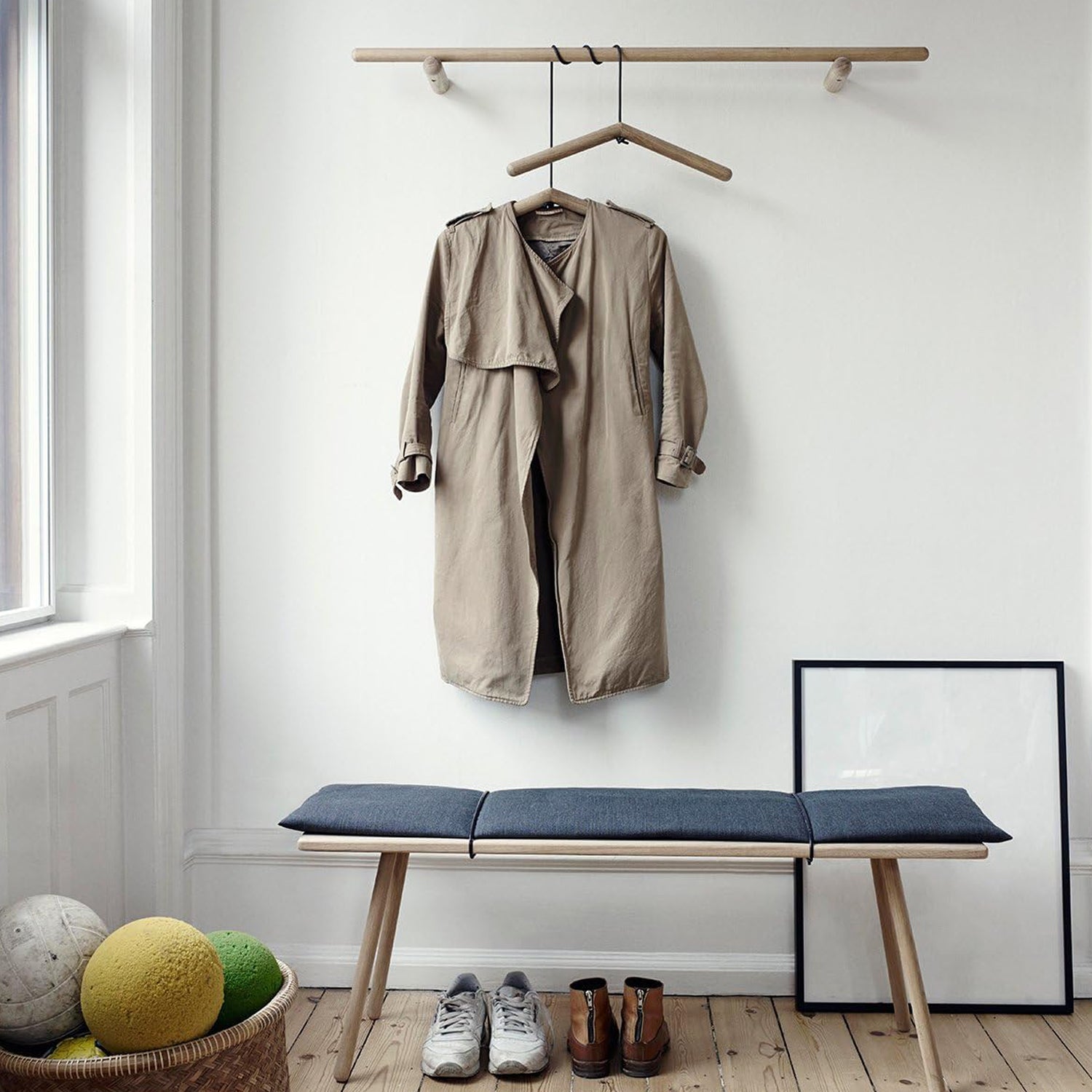 Single wooden clothes hanger with a notched design for coats and suits.