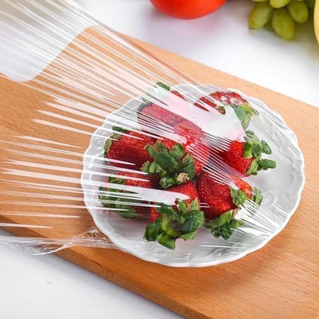 Hand stretching a reusable elastic food cover to demonstrate its flexibility and universal fit.
