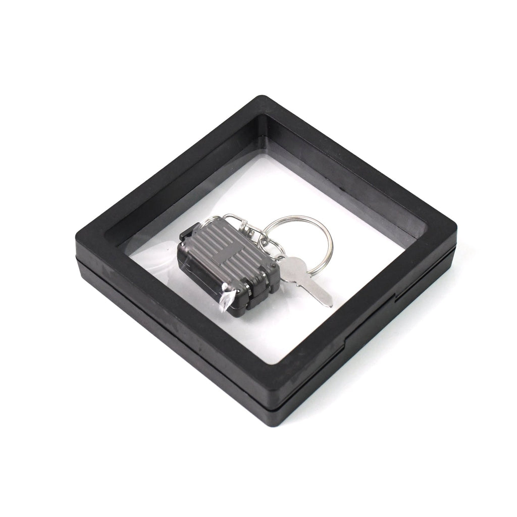 Nail clipper keychain attached to travel essentials with suitcase shape
