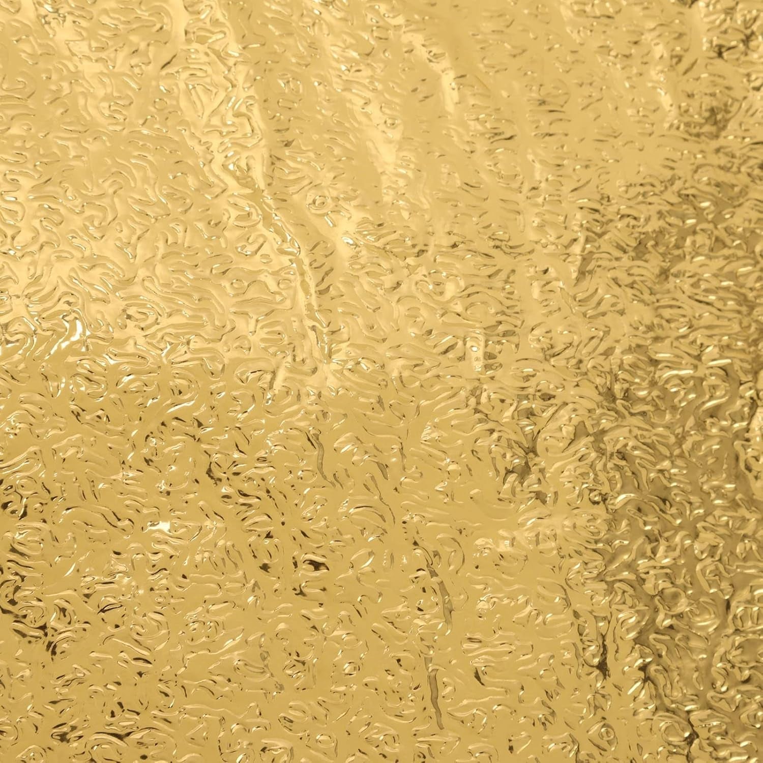 Close-up of a self-adhesive golden kitchen foil sticker roll.