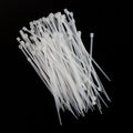 Bundle of 3x100mm heavy-duty black nylon cable ties, ready for use.