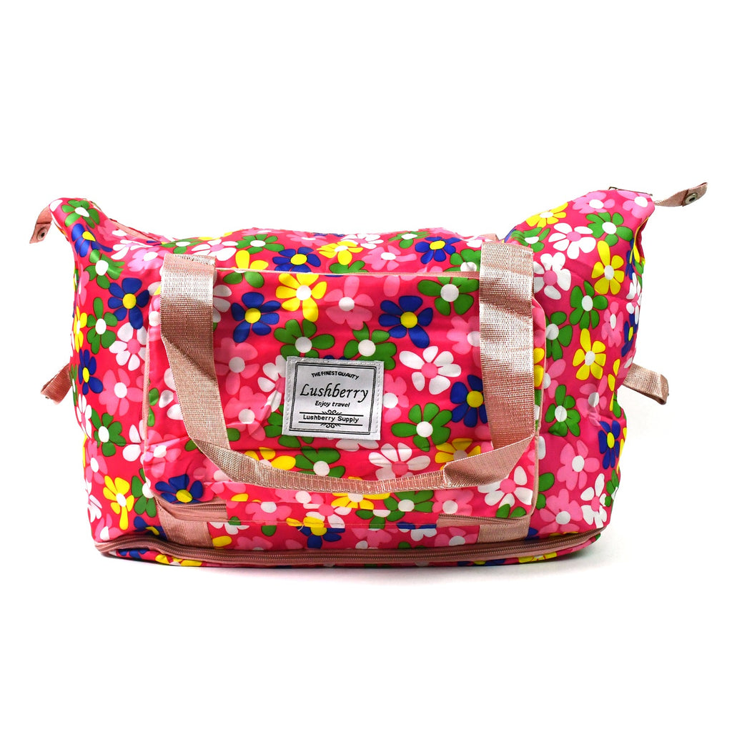The foldable travel bag with its integrated trolley sleeve sliding over a rolling luggage handle.