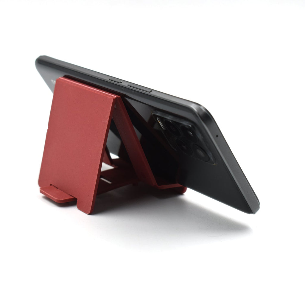 Adjustable phone stand in use on a wooden desk, perfect for video calls.