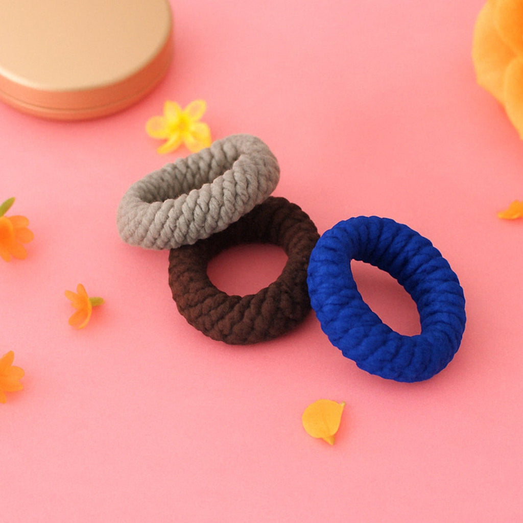 Tyre shape multicolour hair bands in a pack of three, displayed for women.