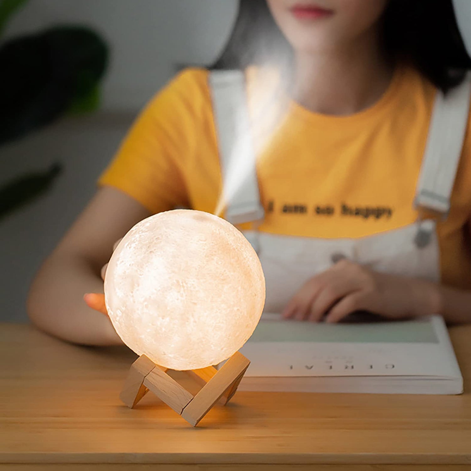 The 3D Moon Lamp Diffuser illuminated in its soothing warm light mode