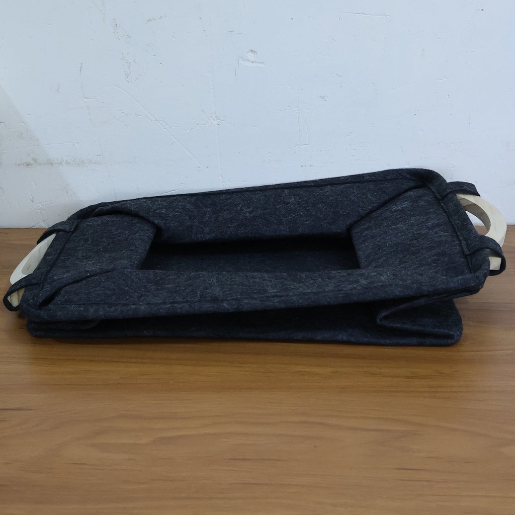 Folded pet toy storage basket, demonstrating its space-saving collapsible design.