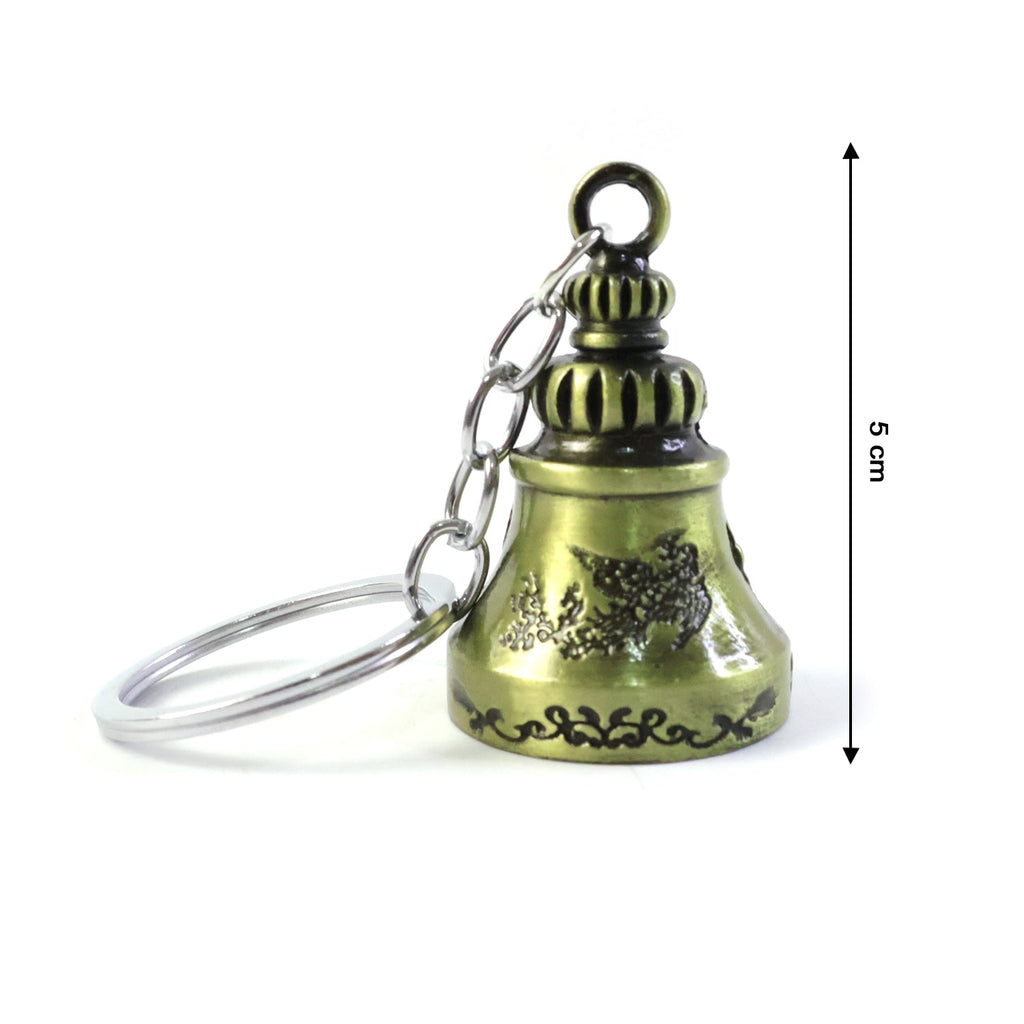 Metal temple bell keychain held in hand showcasing size and design