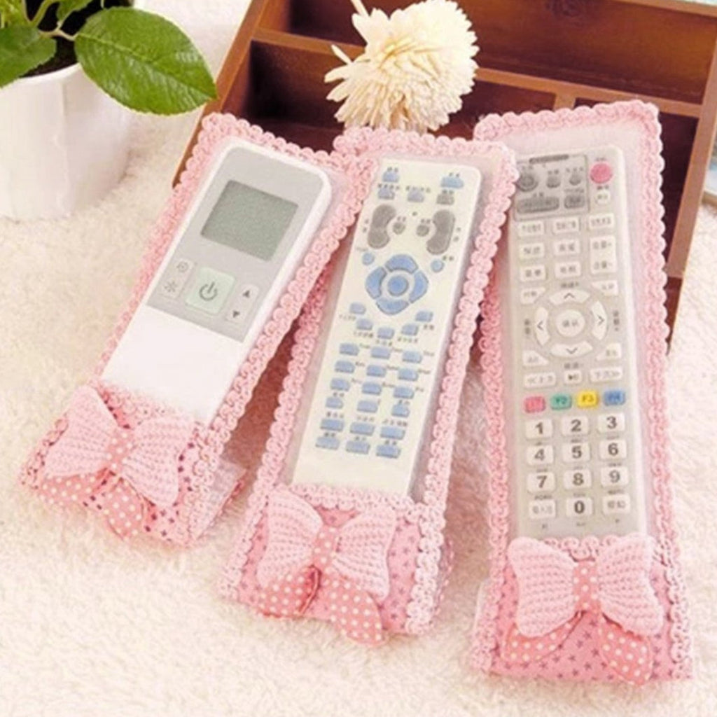 A decorative remote control cover with a bow knot, providing dust protection for TV remotes.