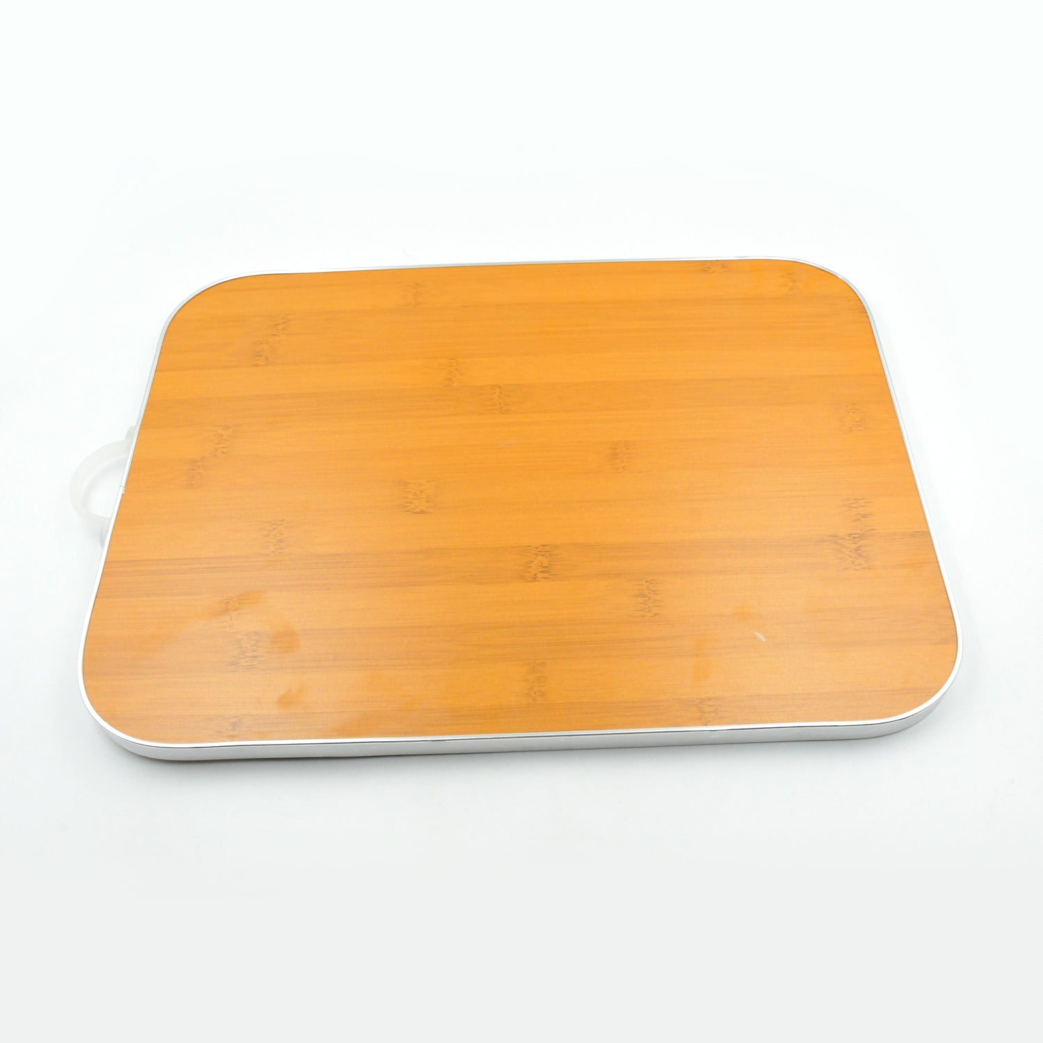 Versatile bamboo cutting board used for various kitchen tasks like slicing vegetables.