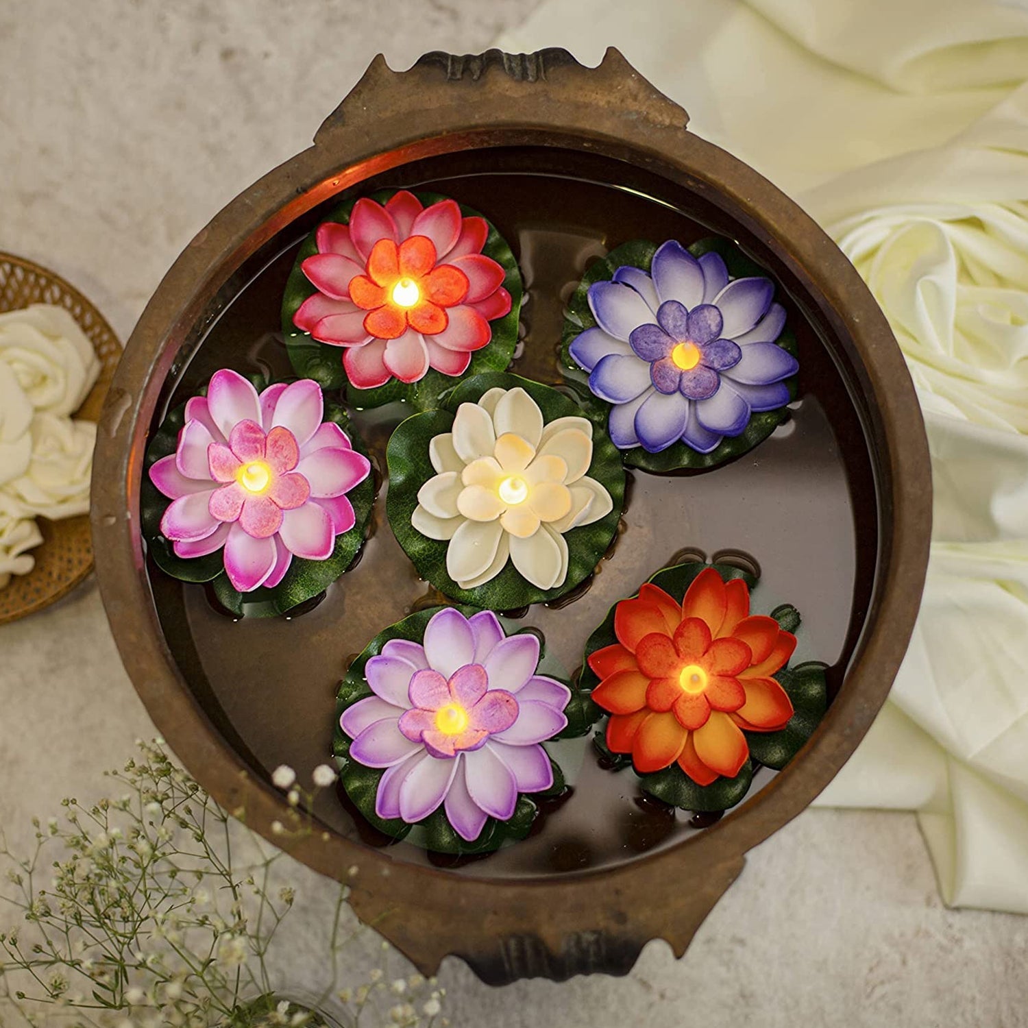Detailed view of the plastic lotus petals and the LED light mechanism of a floating candle.