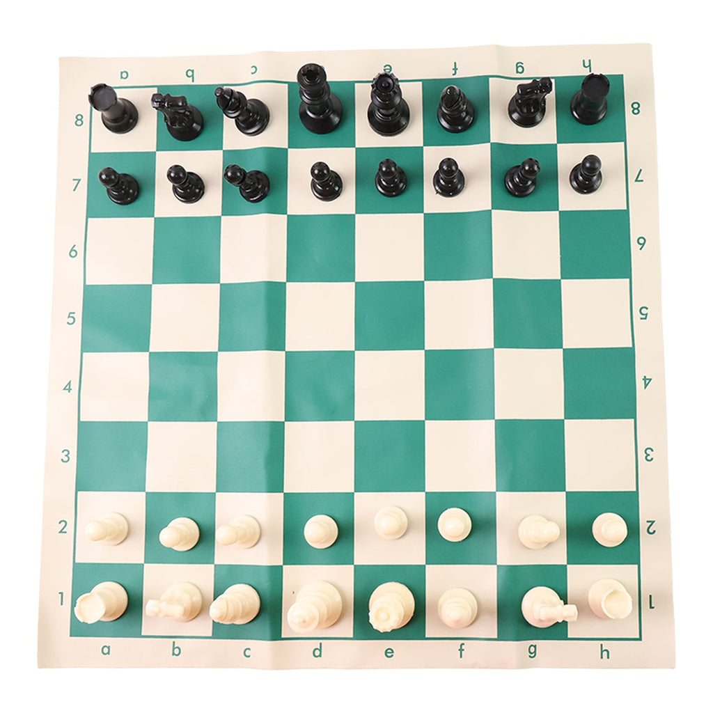 Plastic chess set pieces arranged on the roll-up green and white chess board