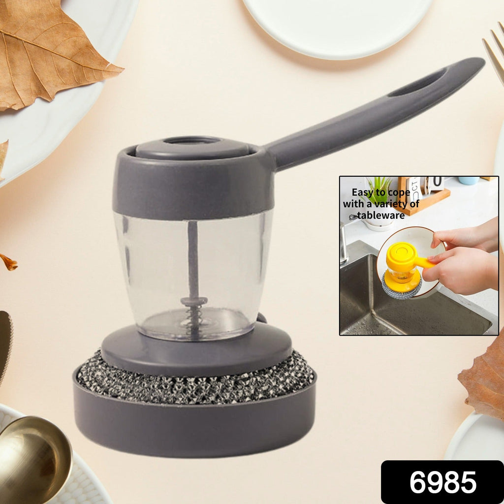 A person using the soap dispenser with scrub to clean a frying pan, emphasizing its cleaning power.
