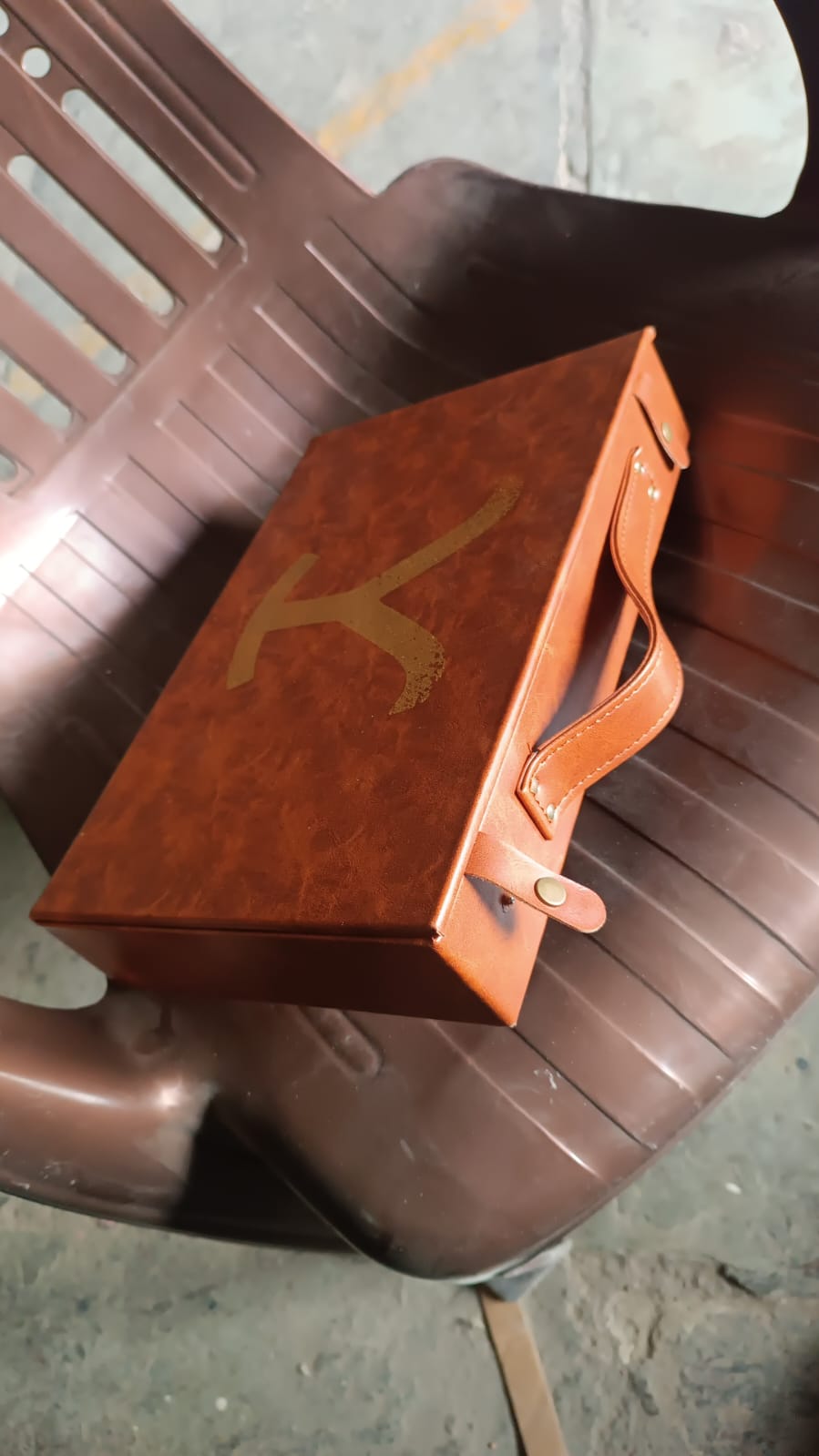 Angled view of the ClassiCarry multi-purpose leather carrying case, highlighting its compact structure.