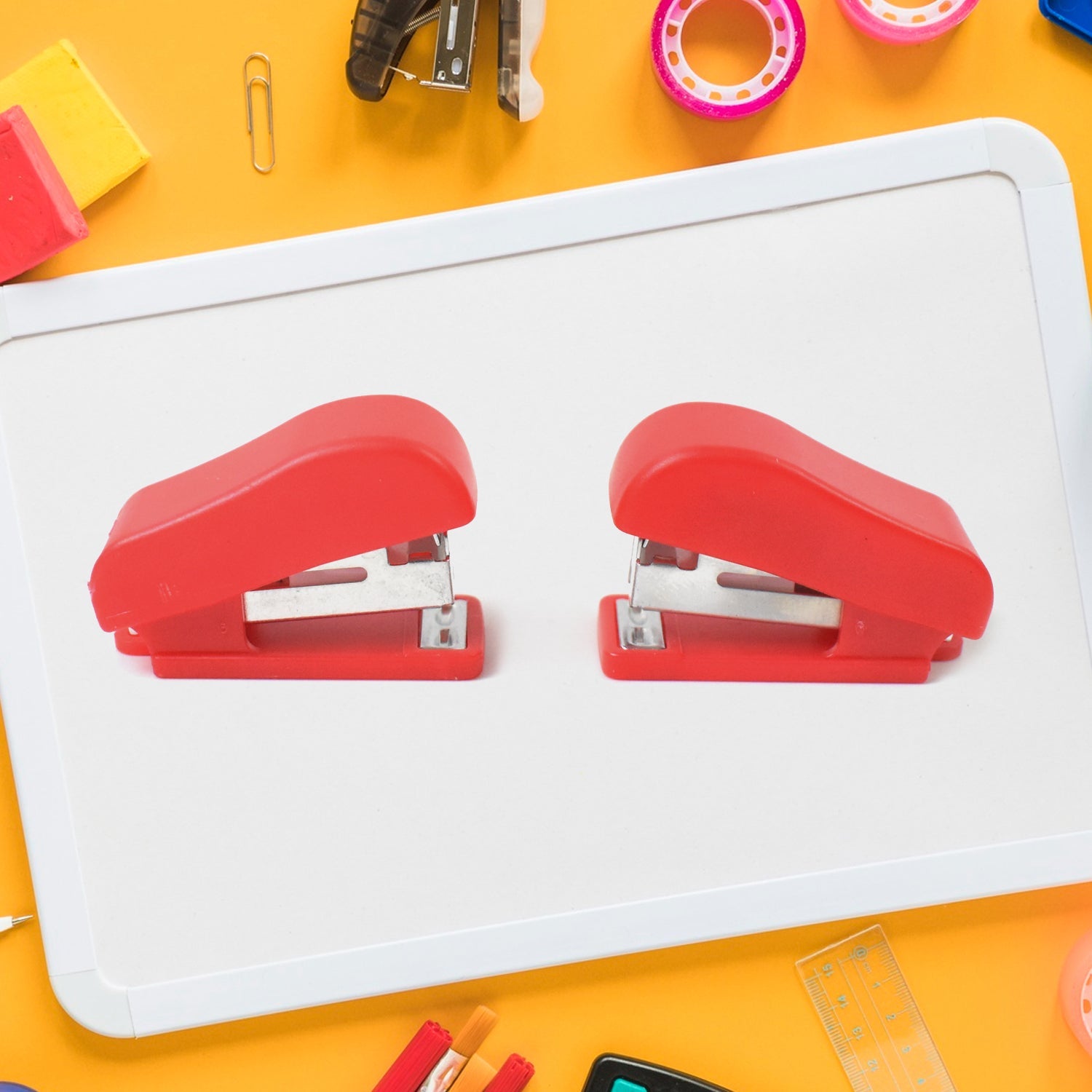 Hand using a FiloDesk mini stapler to bind papers, highlighting its ease of use.