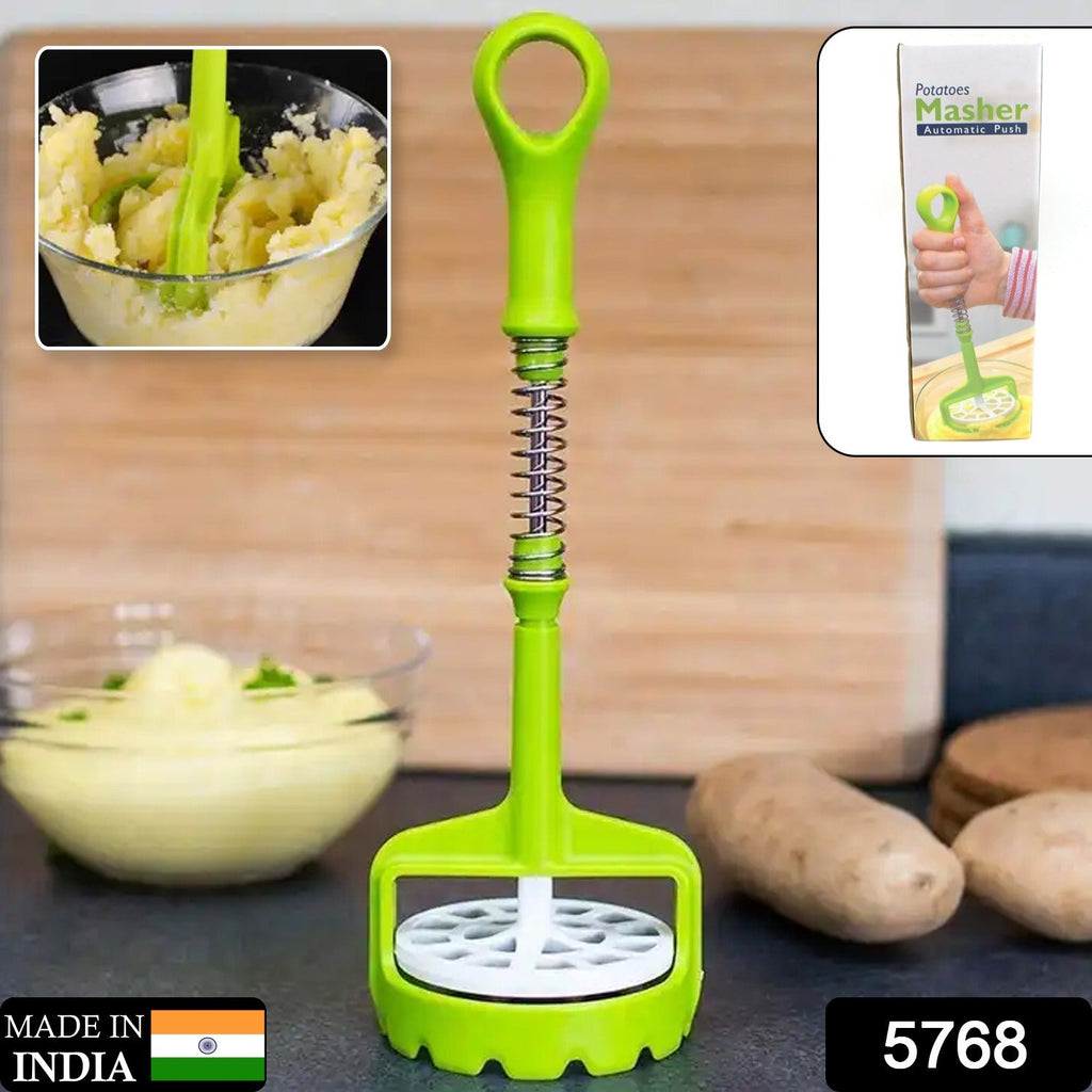 Person mashing boiled potatoes effortlessly with the spring press potato masher.