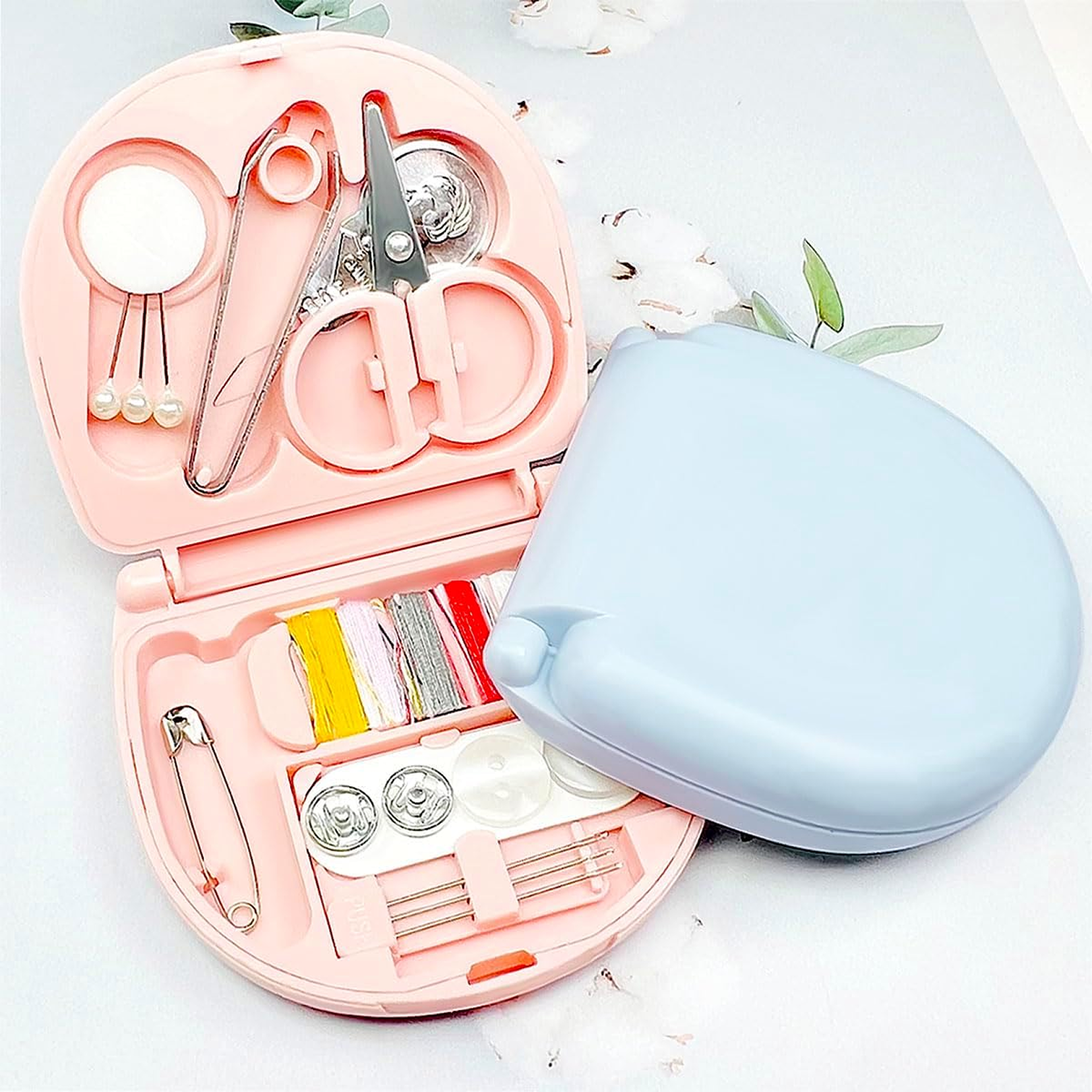 Closed Mini Travel Sewing Kit in a compact plastic case, ready for travel.