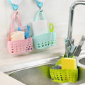 Adjustable plastic faucet sink caddy in a modern kitchen.