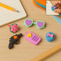 A vibrant assortment of 3D erasers with mixed designs, perfect for school kids.