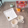 Ceramic tea cups paired with plastic square serving platter for stylish tea serving