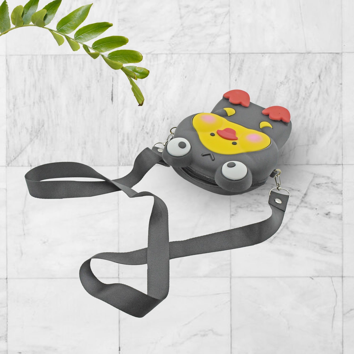 A hand holding the Cartoon Girls Backpack, illustrating its mini size and portability for young users.