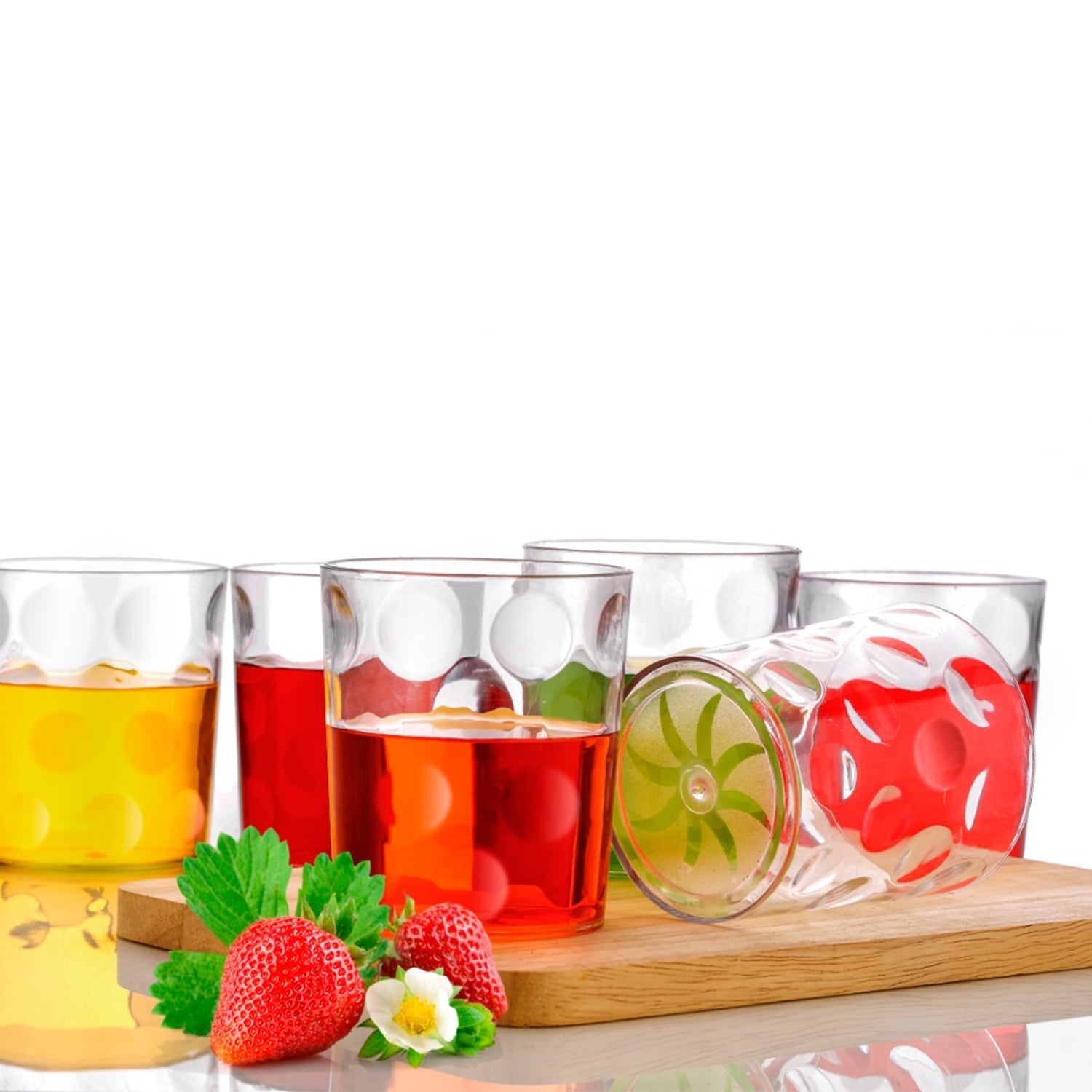 Group of transparent unbreakable glasses arranged neatly on a table, ready for serving.