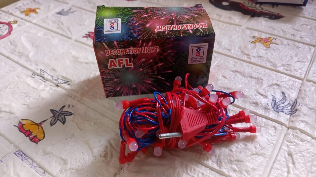 A coil of multi-color LED string lights ready for festival decoration.