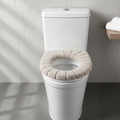 Plush Toilet Seat Cover in a serene white bathroom setting, offering warmth and comfort.