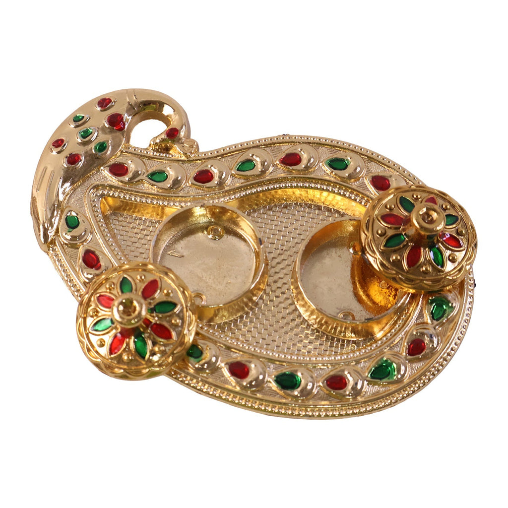 Golden Kankavati holder in use during a pooja ceremony