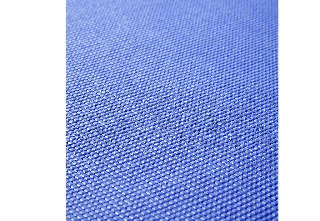 Eco-friendly Yoga Mat unrolled on a wooden floor.
