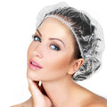 A stack of individually wrapped disposable shower caps, ready for use.
