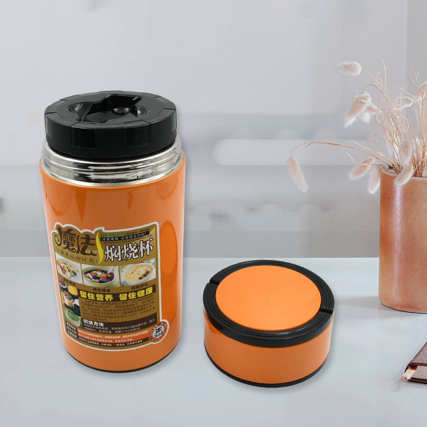 A sleek 1000ml Stainless Steel Water Bottle from VoltDesk with a foldable spoon and handle, shown against a clean background.