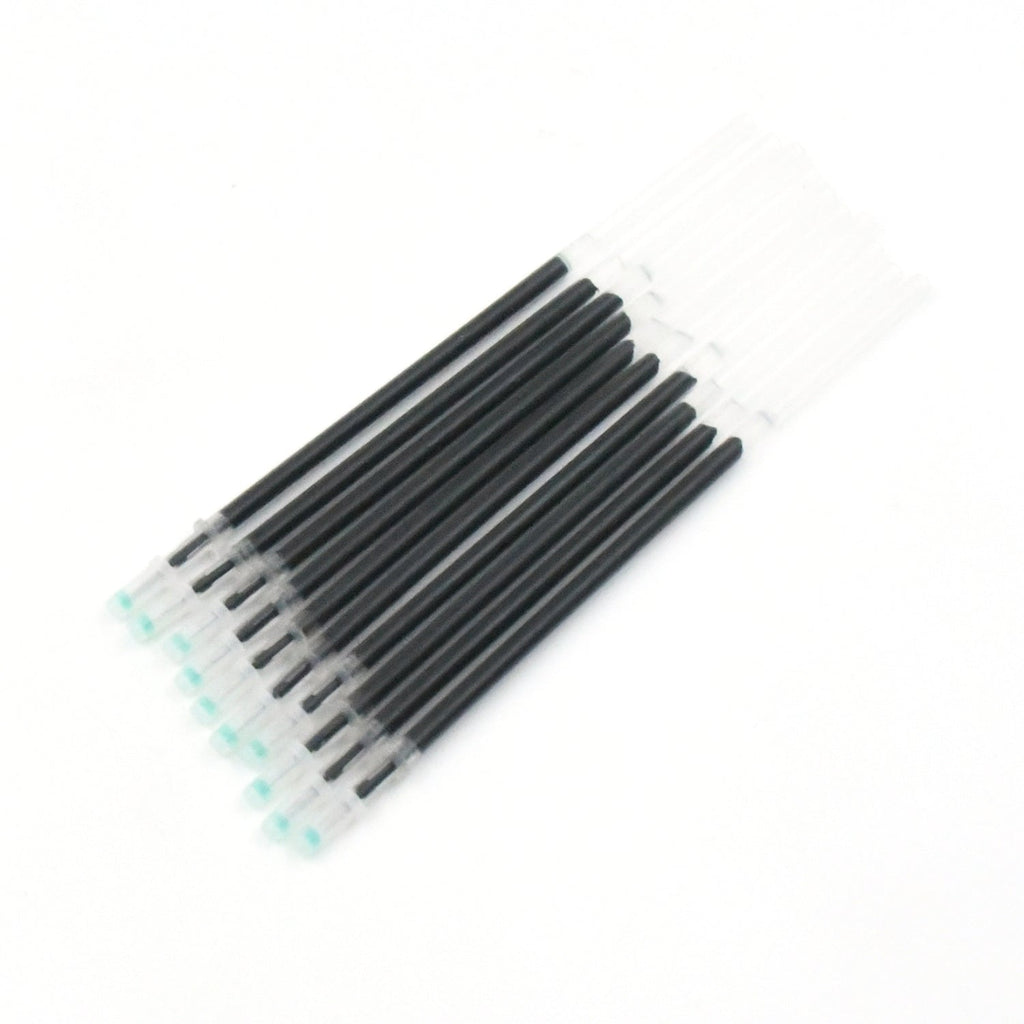 Multiple InkGlow black pen refills arranged neatly on a surface.