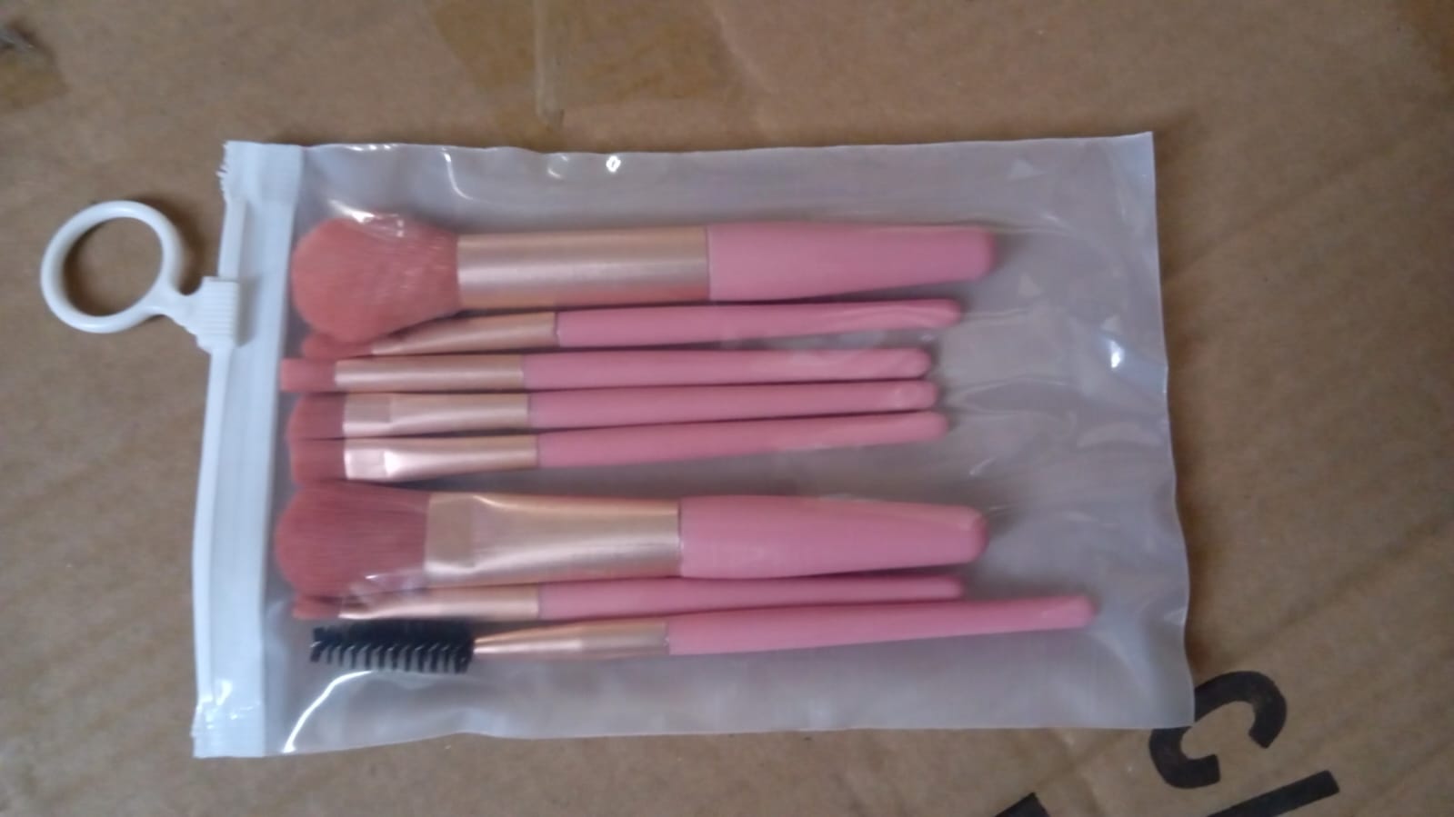 A close-up view of the secure aluminum ferrules connecting bristles to handles on the makeup brushes.