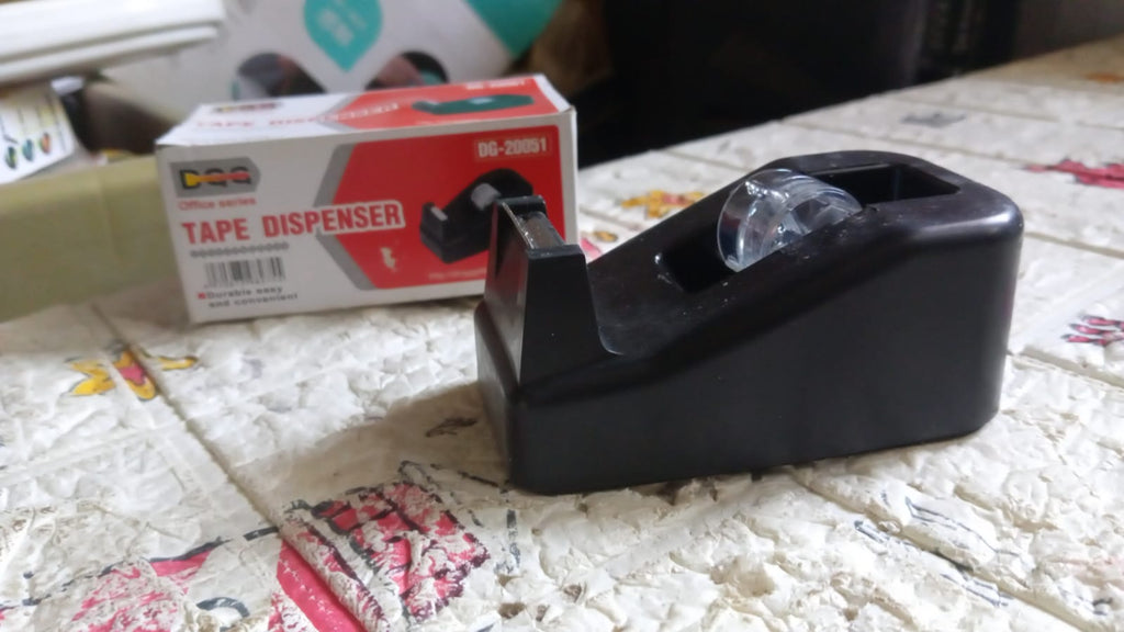 The VoltDesk tape dispenser in its original product packaging, displayed on a clean surface.