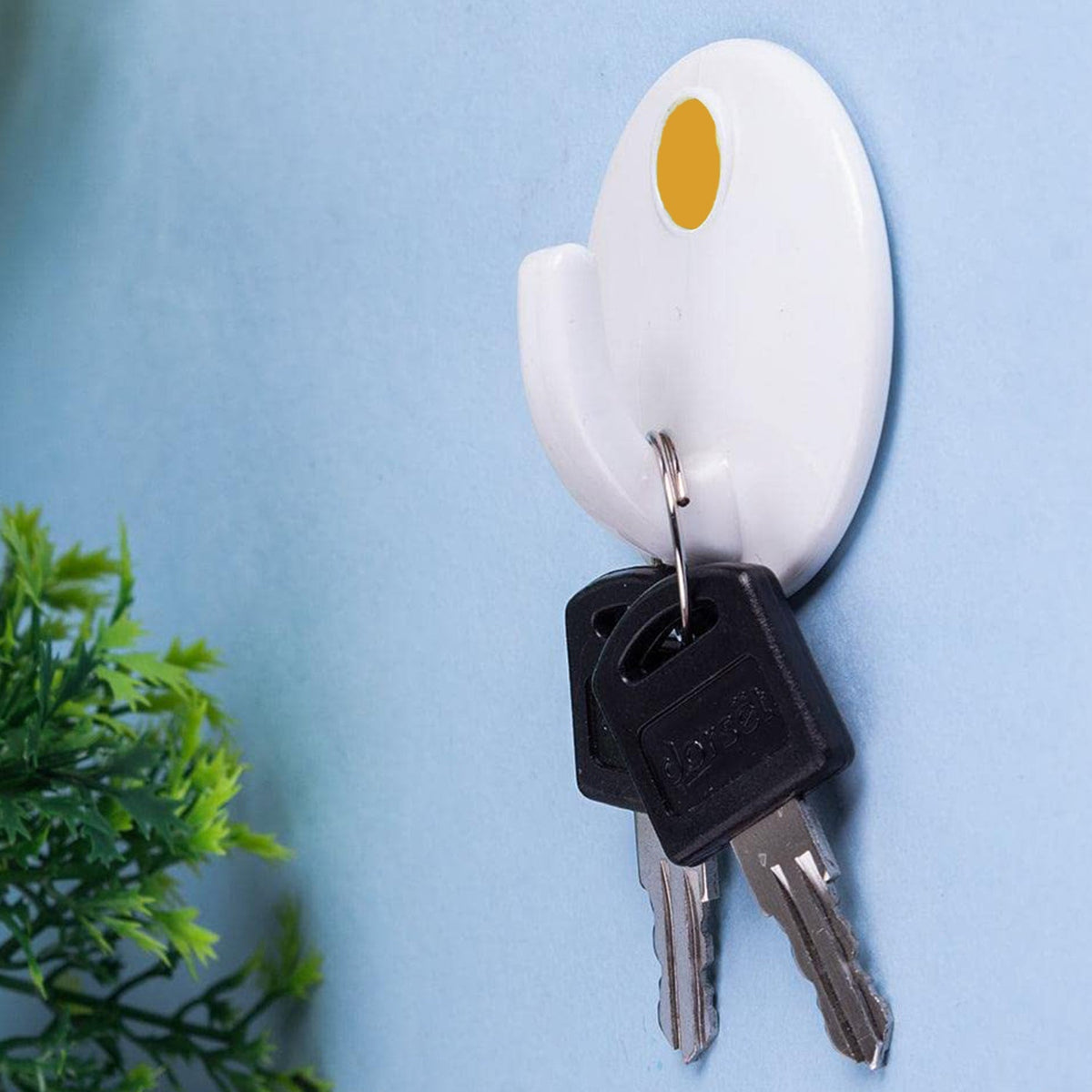 Set of three GlimmerHome self-adhesive wall hooks in a modern design, ready for home organization.