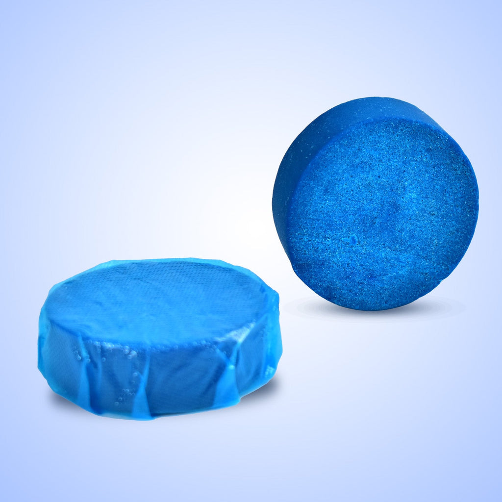 Hand placing a blue toilet cleaner tablet into a toilet tank.