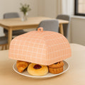 Foldable Food Cover open on a rustic wooden table, ready to protect dishes.